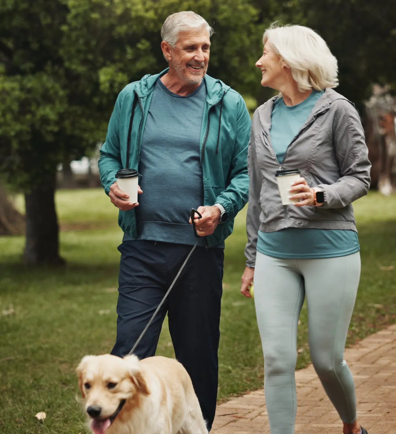 A couple walking their dog through the estate